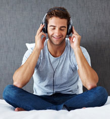 Relaxed young guy listening to peaceful music